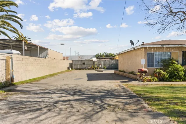 a swimming pool with yard in front of it