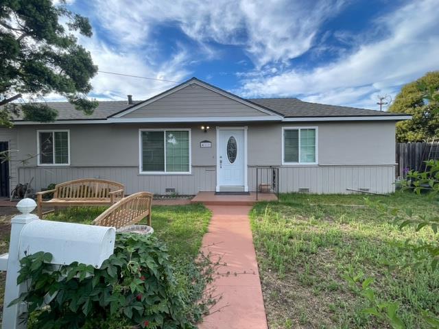 a front view of house with yard and green space