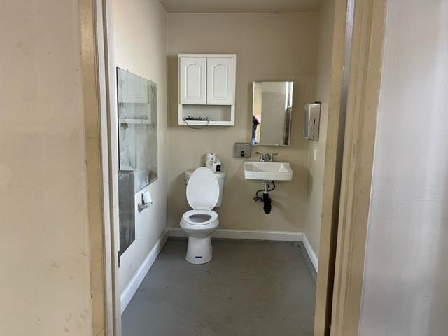 411 Lewis Street Gilroy, CA 95020 - Photo 16 of 22 a white toilet sitting next to a bathroom sink