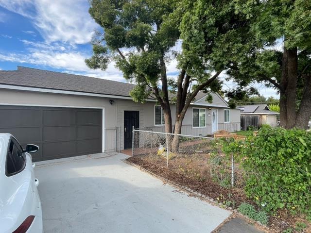 411 Lewis Street Gilroy, CA 95020 - Photo 2 of 22 a front view of a house with garden