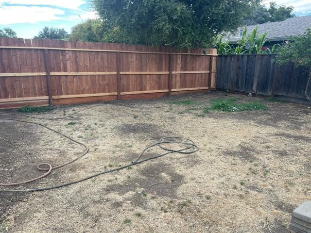 411 Lewis Street Gilroy, CA 95020 - Photo 21 of 22 a view of a backyard with wooden fence
