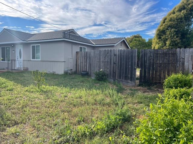 411 Lewis Street Gilroy, CA 95020 - Photo 3 of 22 a backyard of a house with lots of green space