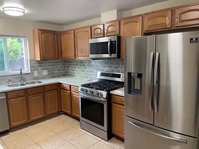 411 Lewis Street Gilroy, CA 95020 - Photo 4 of 22 a kitchen with stainless steel appliances granite countertop a refrigerator stove and sink