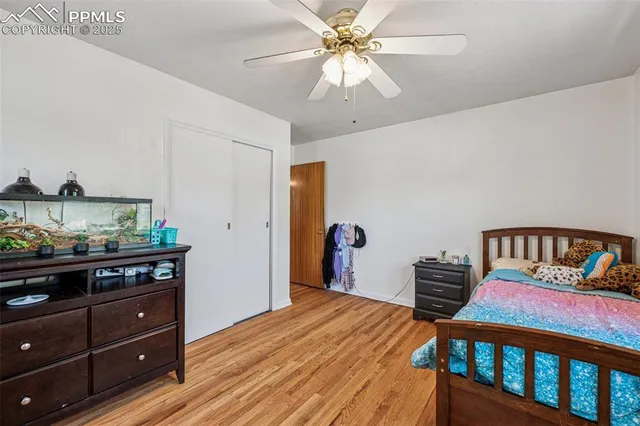 a bedroom with furniture and wooden floor