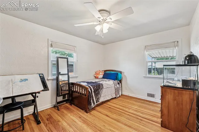 a view of a bedroom with furniture and wooden floor