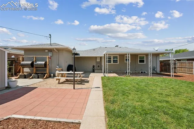 a view of a house with backyard porch and sitting area