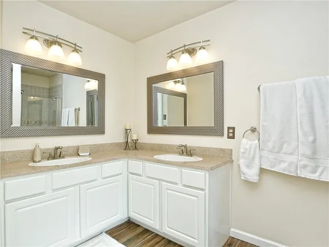 a bathroom with a double vanity sink and mirror