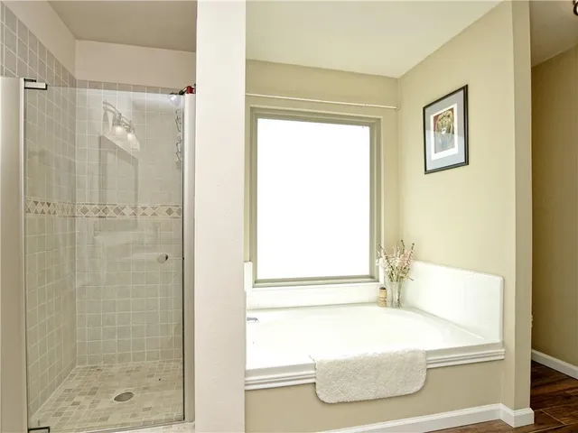 a bathroom with a bathtub and a shower