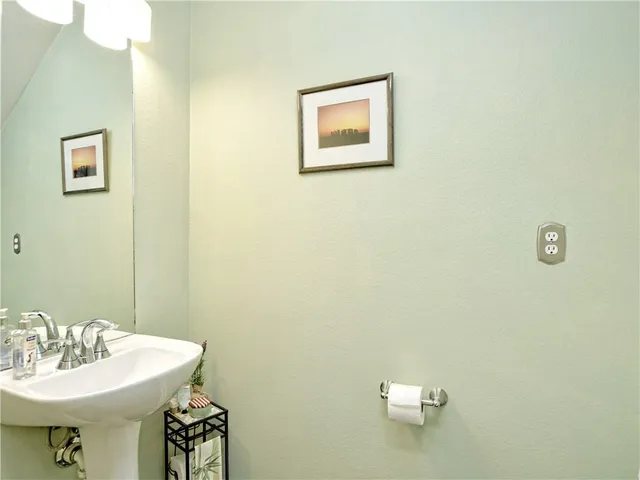 a bathroom with a sink mirror and toilet