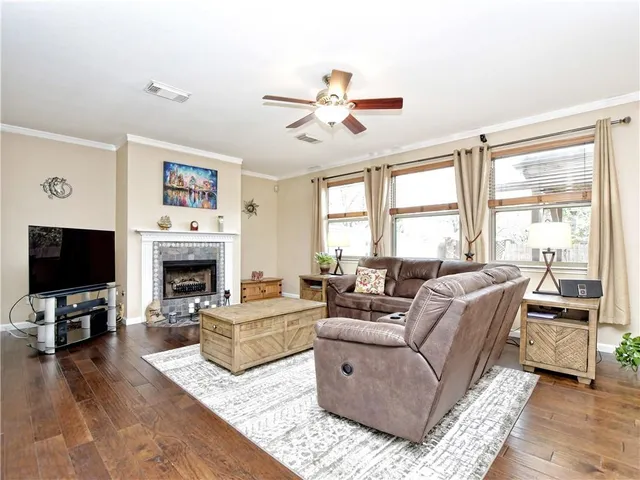 a living room with furniture a fireplace and a flat screen tv