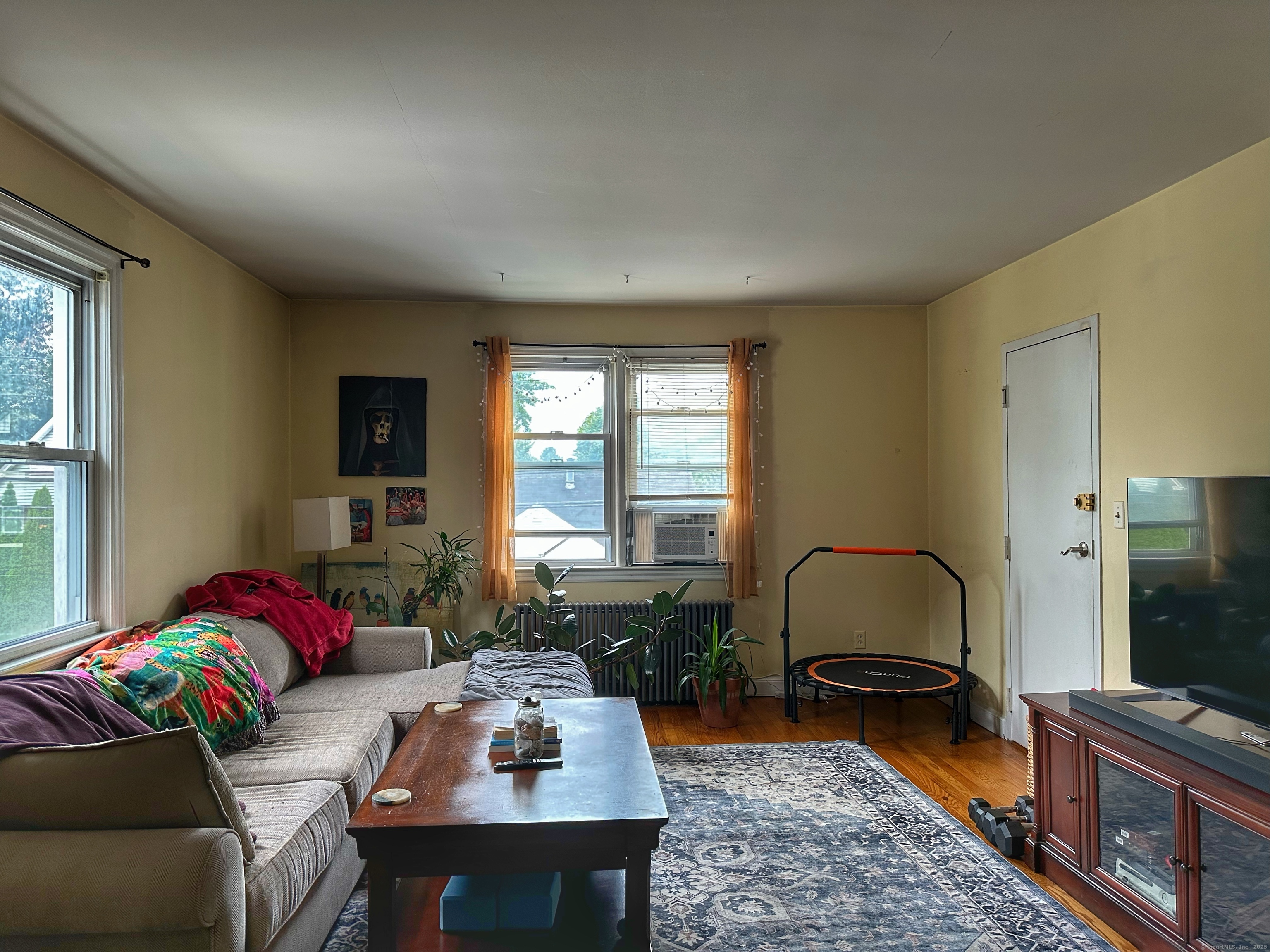 181 Fox Street, Unit 2 Bridgeport, CT 06605 - Photo 2 of 7 a living room with furniture and a flat screen tv