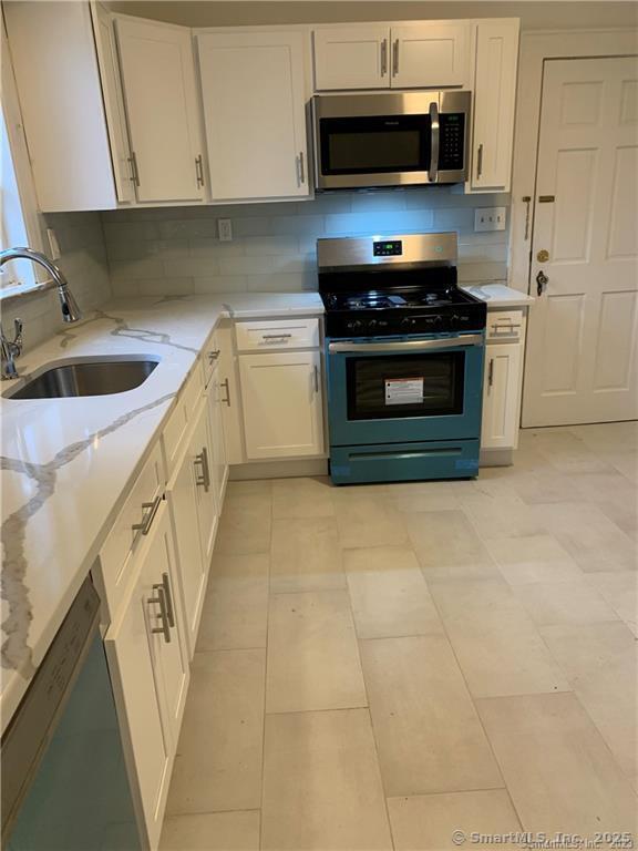 181 Fox Street, Unit 2 Bridgeport, CT 06605 - Photo 4 of 7 a kitchen with a stove and a sink