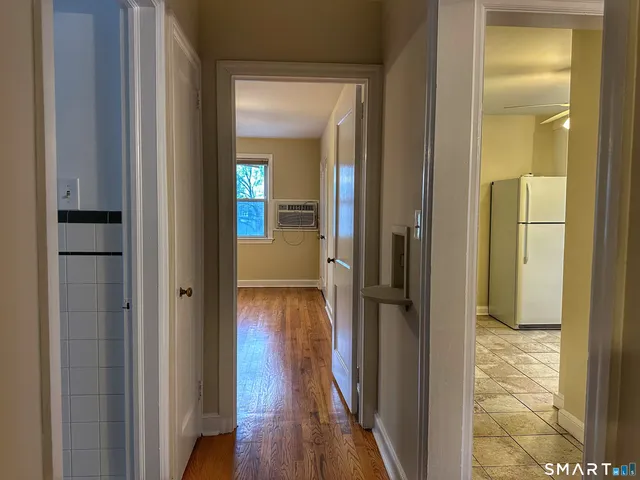 a view of a hallway with wooden floor