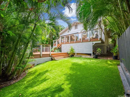 a house view with a sitting space and garden