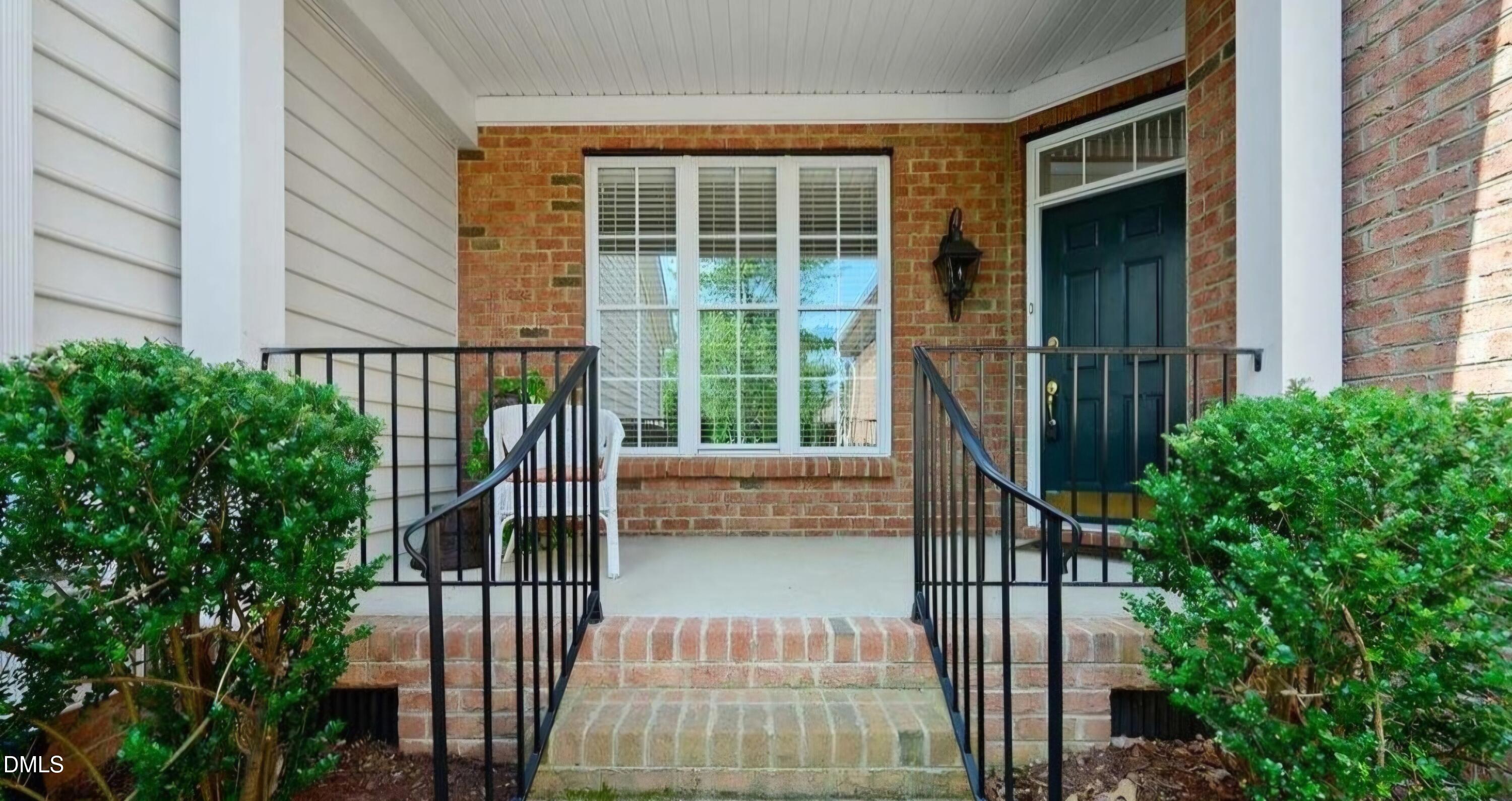 9569 Brookchase Drive Raleigh, NC 27617 - Photo 2 of 7 a balcony with table and chairs