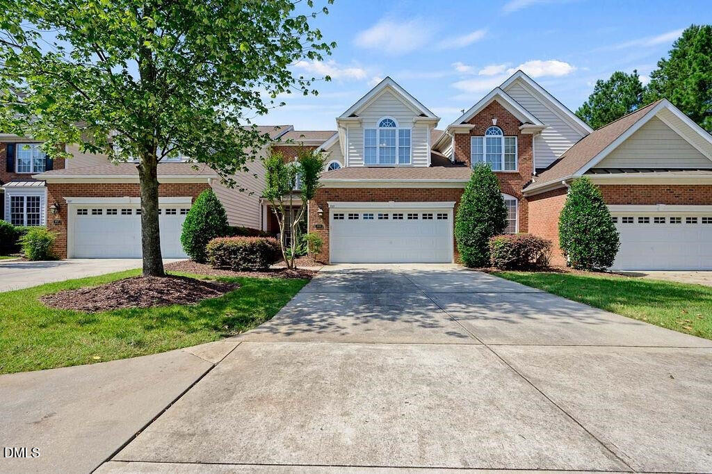 9569 Brookchase Drive Raleigh, NC 27617 - Photo 4 of 7 a front view of a house with a yard and garage
