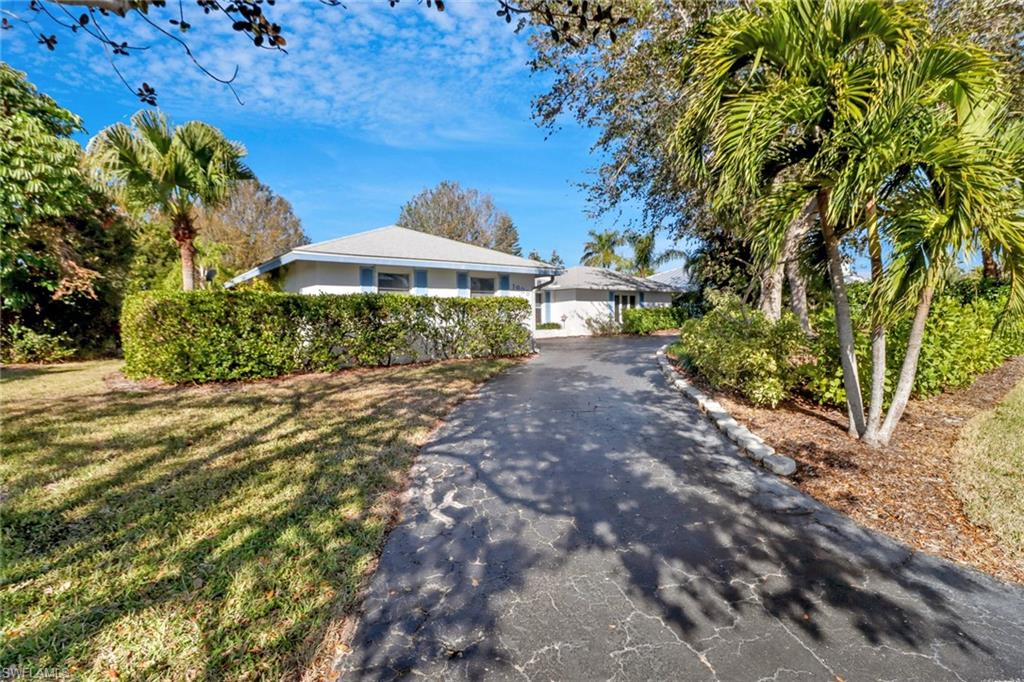 1999 Alamanda Drive Naples, FL 34102 - Photo 1 of 24 a front view of a house with a yard