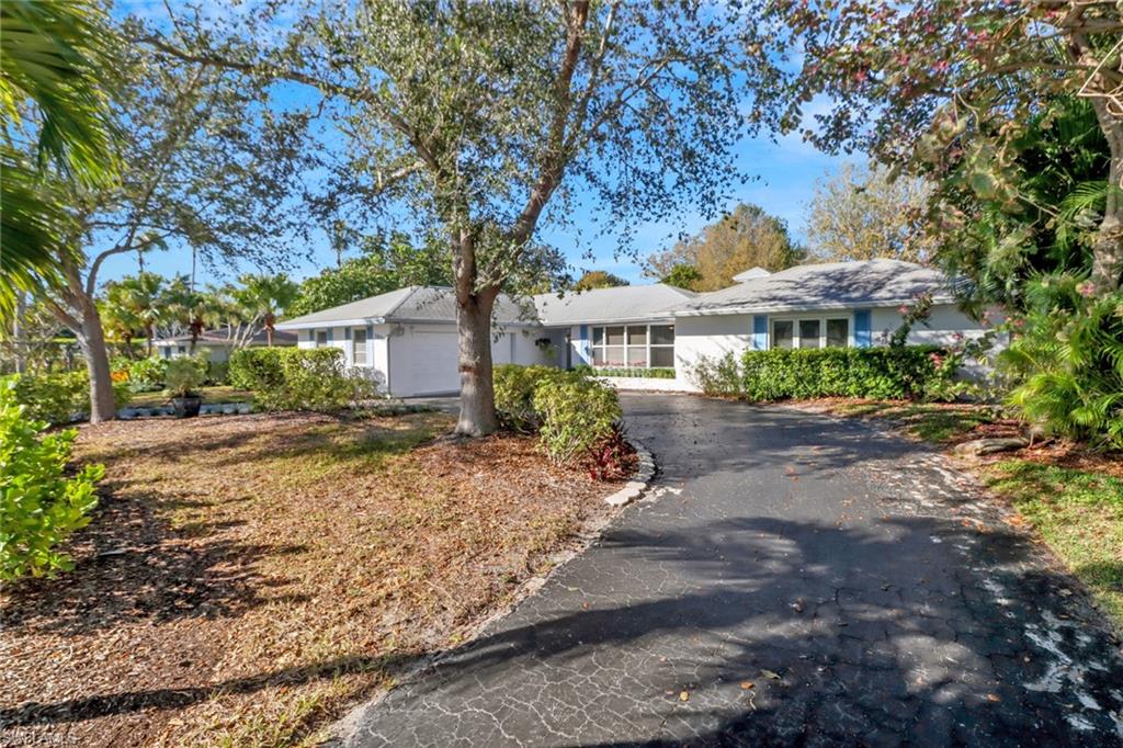 1999 Alamanda Drive Naples, FL 34102 - Photo 22 of 24 a view of a town with large trees and a barn