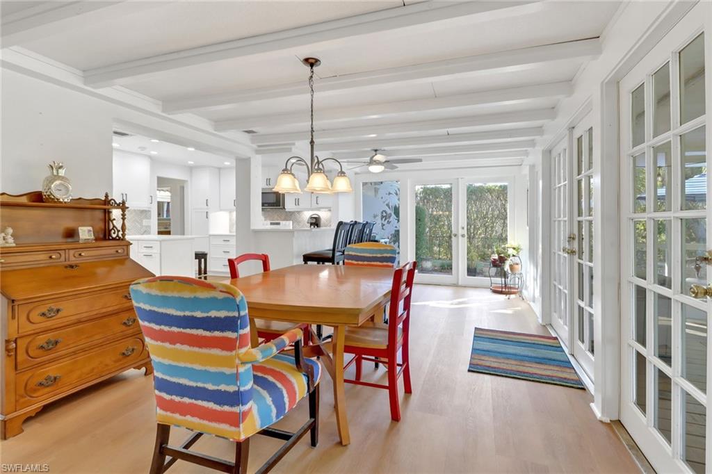 1999 Alamanda Drive Naples, FL 34102 - Photo 6 of 24 a view of a dining room and livingroom with furniture wooden floor a chandelier