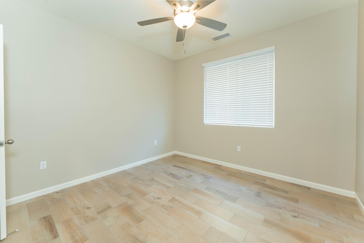 30480 Bellwood Road Visalia, CA 93291 - Photo 24 of 37 an empty room with a window and a fan