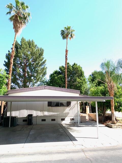 169 Tanforan Rancho Mirage, CA 92270 - Photo 1 of 19 a front view of a house with a garden