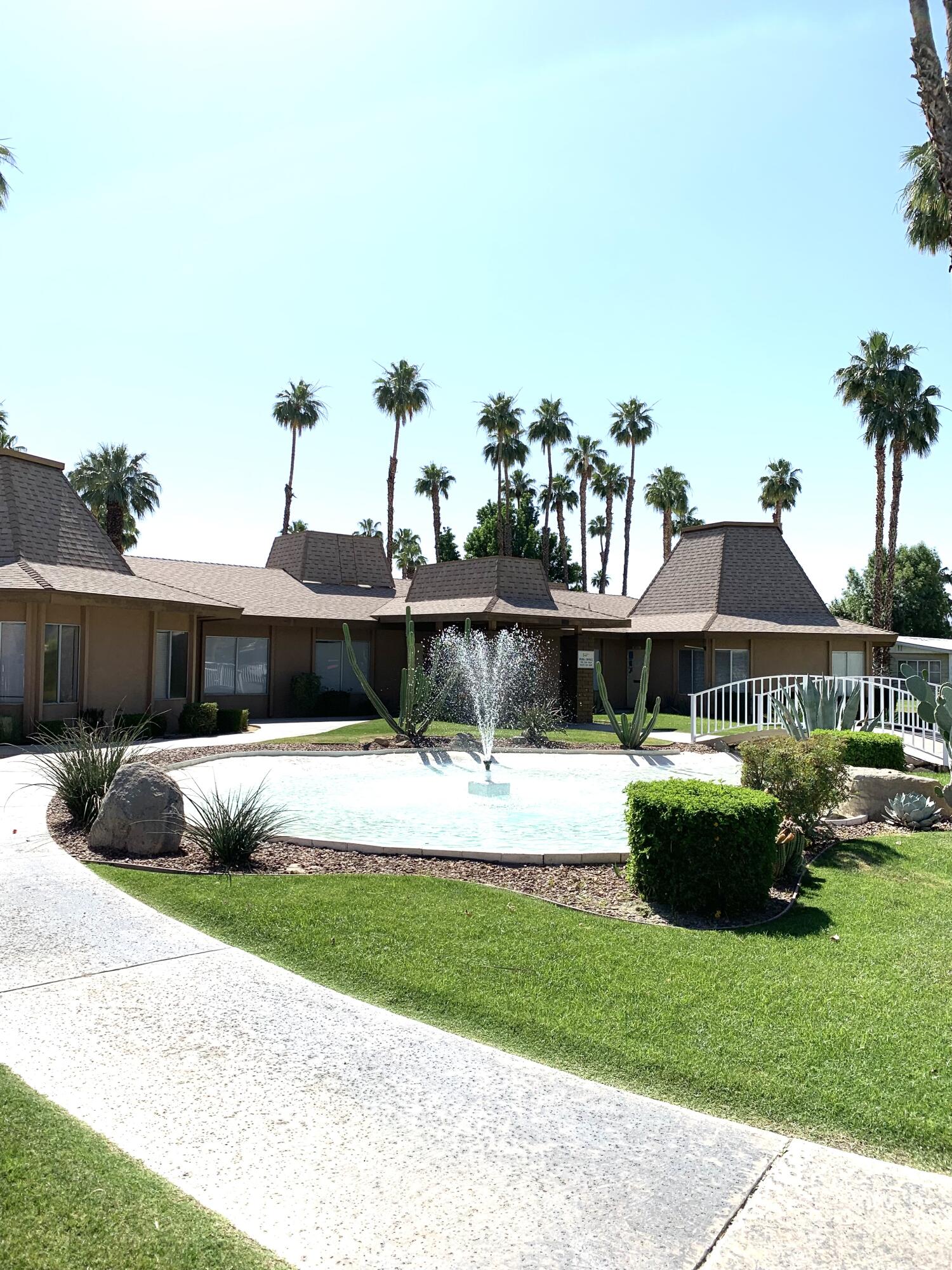 169 Tanforan Rancho Mirage, CA 92270 - Photo 17 of 19 a view of a house with backyard sitting area and garden