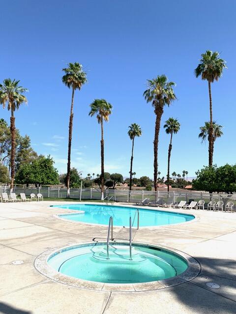 169 Tanforan Rancho Mirage, CA 92270 - Photo 18 of 19 a view of a swimming pool with a table and chairs