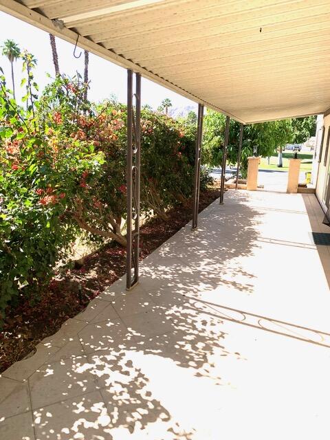 169 Tanforan Rancho Mirage, CA 92270 - Photo 2 of 19 a view of a porch with a floor to ceiling window next to a yard