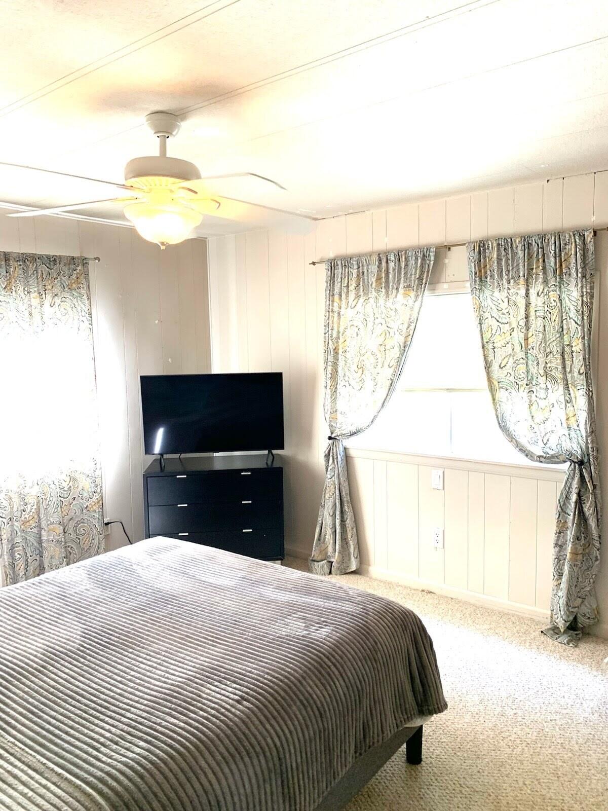 169 Tanforan Rancho Mirage, CA 92270 - Photo 9 of 19 a bedroom with a bed and a flat tv screen