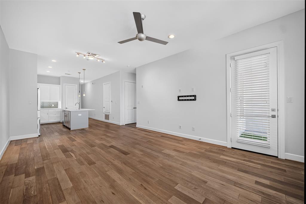 5015 Meridian Lane, Unit 2102 Addison, TX 75001 - Photo 5 of 36 Expansive living area featuring wide plank wood-finish flooring