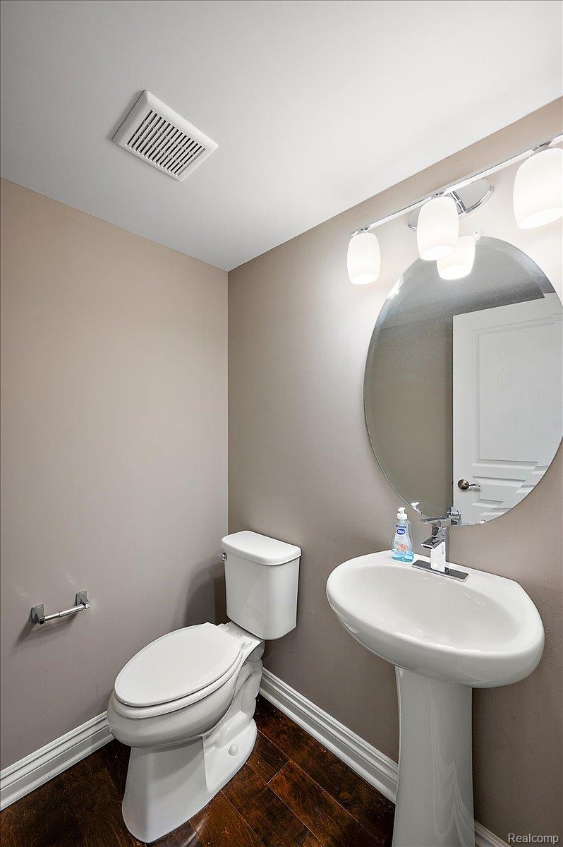 2877 Hartwick Drive Rochester, MI 48307 - Photo 26 of 44 Bathroom with dark wood-style floors and baseboards