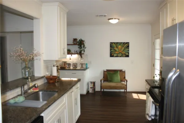 a kitchen with sink and refrigerator