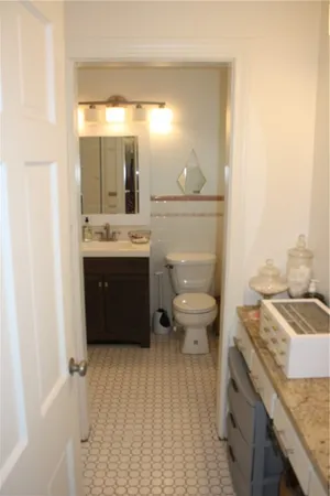 a spacious bathroom with a granite countertop sink and a mirror