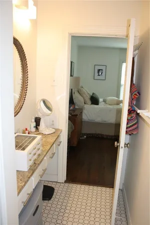 a bedroom with a bed and a mirror