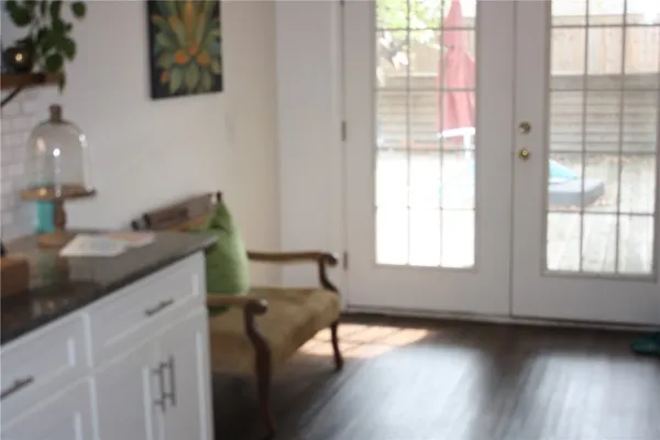 a kitchen with a sink wooden floor and a large window