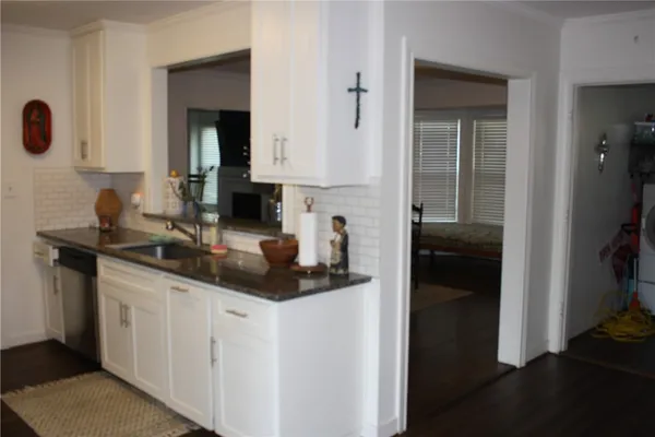 a kitchen with stainless steel appliances granite countertop a sink and a refrigerator