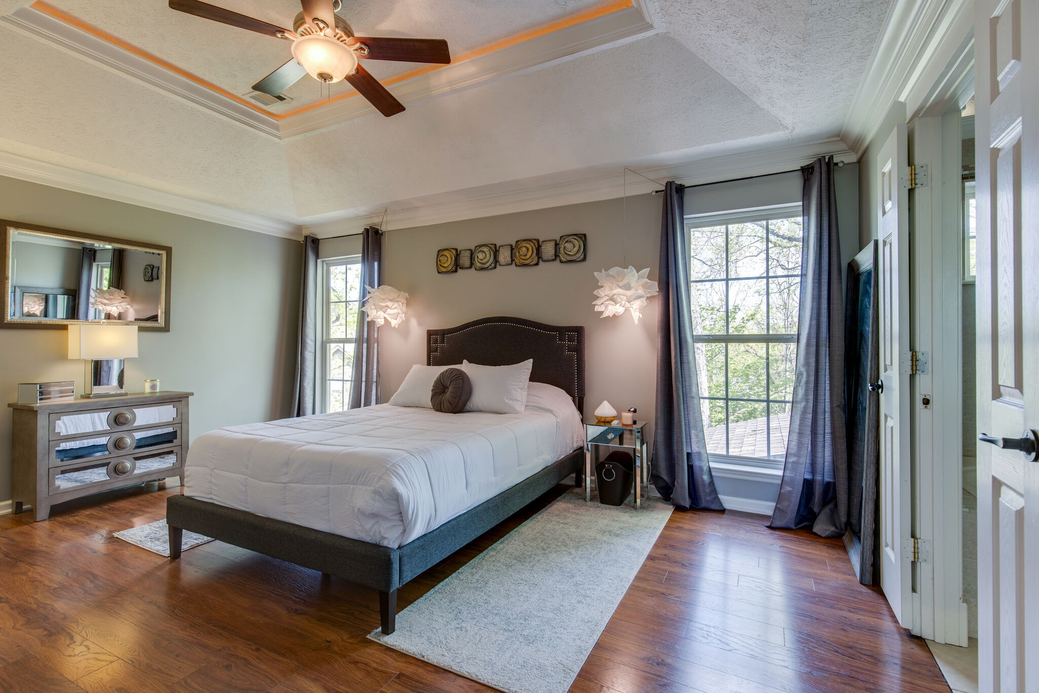 5236 Ridgefalls Way Antioch, TN 37013 - Photo 17 of 35 a bedroom with a large bed and a chandelier