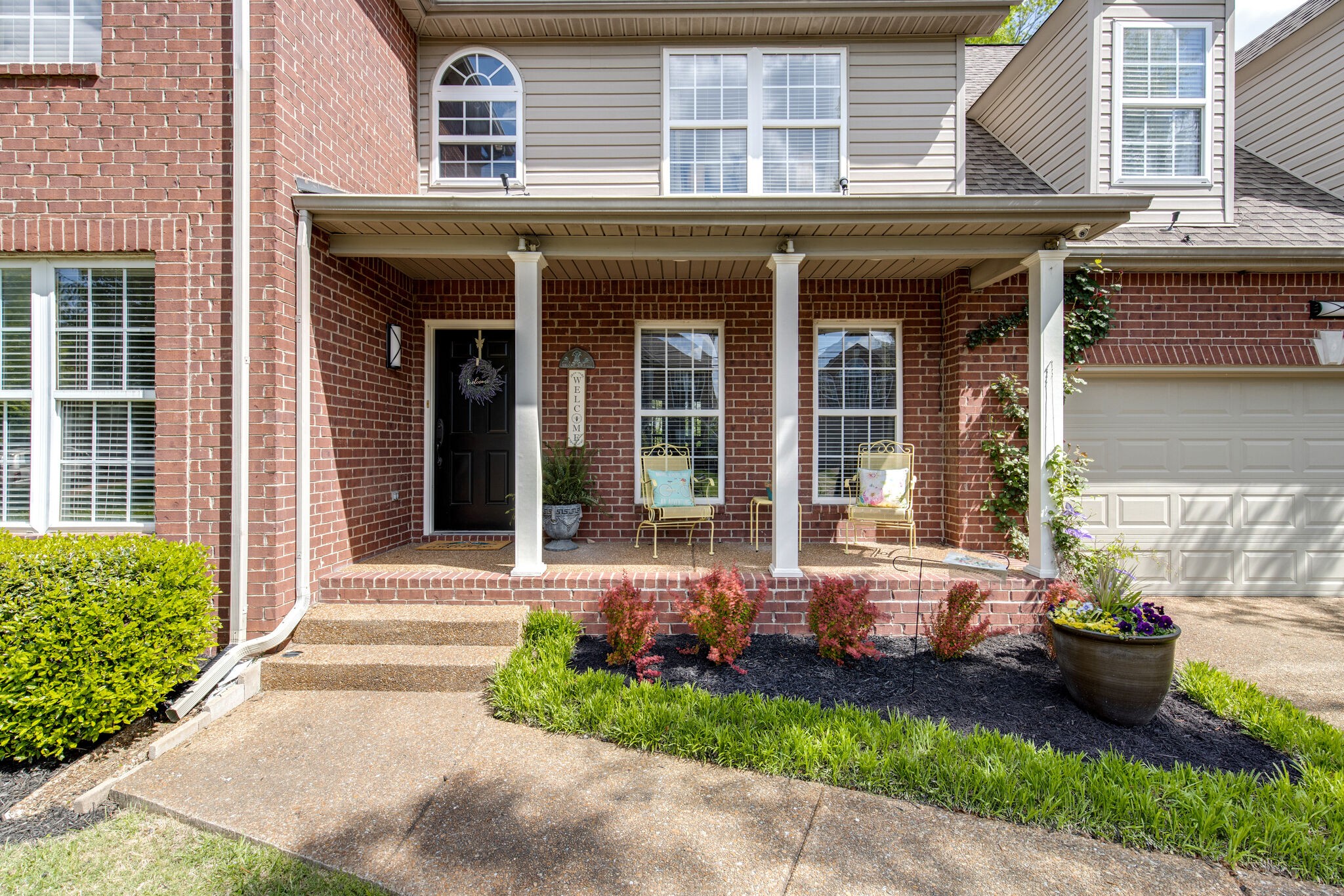 5236 Ridgefalls Way Antioch, TN 37013 - Photo 3 of 35 a front view of a house with a garden and plants