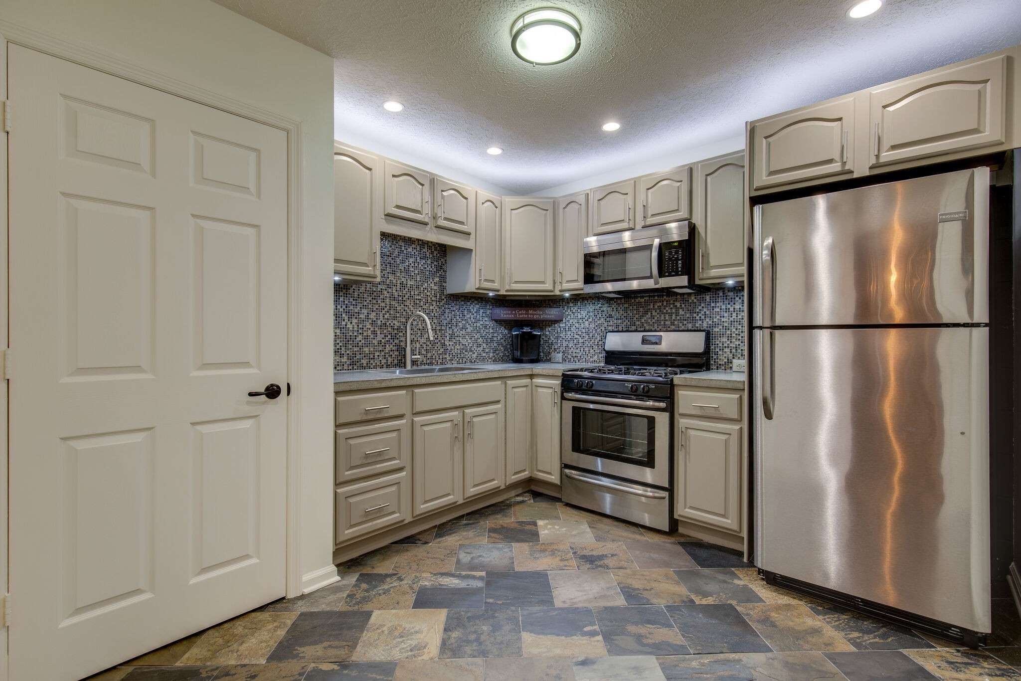 5236 Ridgefalls Way Antioch, TN 37013 - Photo 27 of 35 a kitchen with granite countertop a refrigerator stove top oven and sink