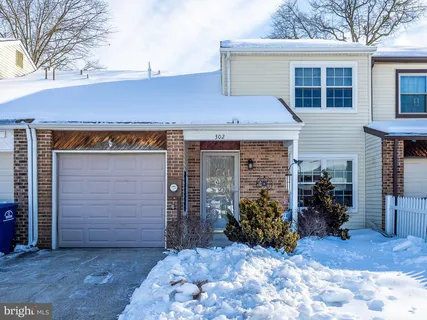 a view of a terrace that has a small barn in front of it