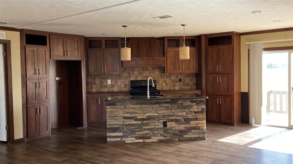 8578 County Road 502 Blue Ridge, TX 75424 - Photo 2 of 15 a view of a livingroom with wooden floor and kitchen space