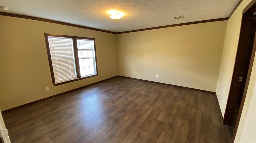 8578 County Road 502 Blue Ridge, TX 75424 - Photo 6 of 15 a view of an empty room with wooden floor and a window