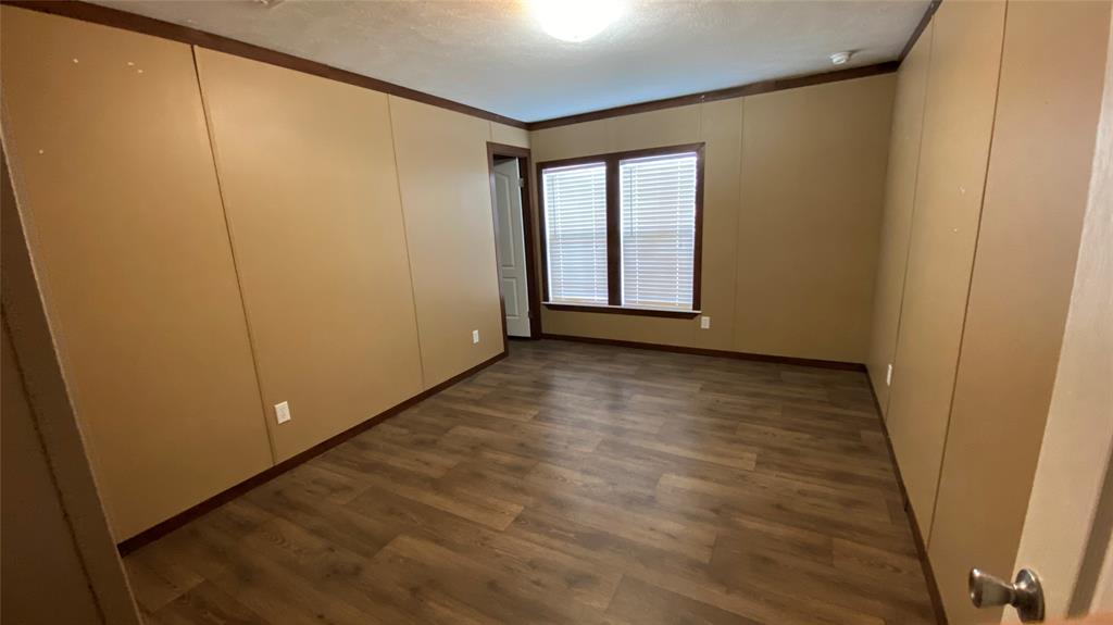 8578 County Road 502 Blue Ridge, TX 75424 - Photo 8 of 15 a view of an empty room with wooden floor and a window