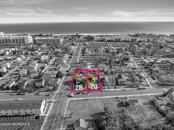 an aerial view of residential building and ocean