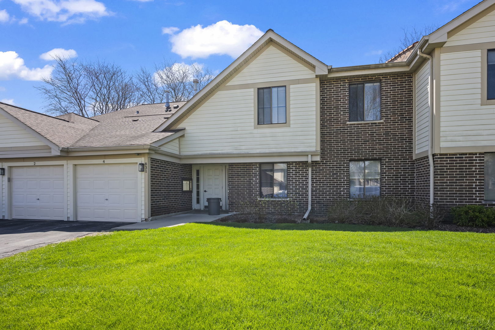 a view of a house with a yard and pathway
