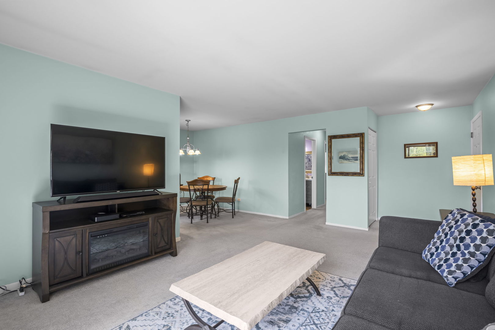 831 Coach Road, Unit 4 Palatine, IL 60074 - Photo 16 of 18 a living room with furniture and a flat screen tv