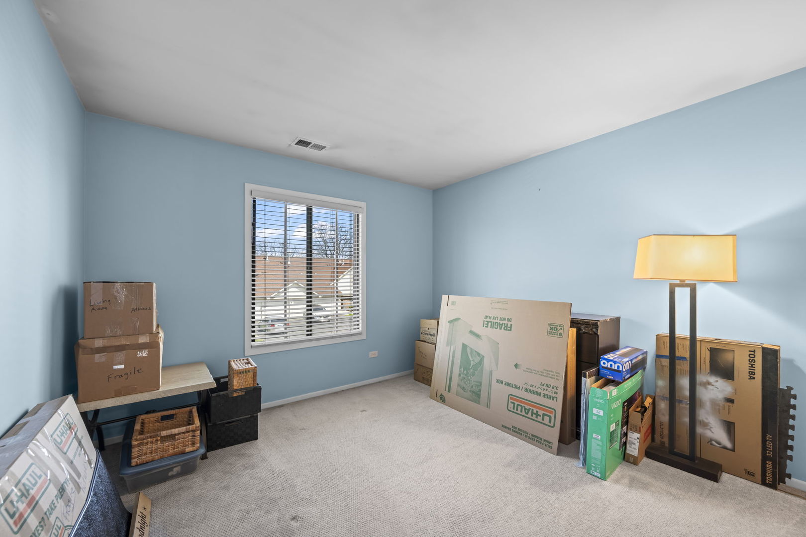 831 Coach Road, Unit 4 Palatine, IL 60074 - Photo 10 of 18 a room with furniture and a flat screen tv