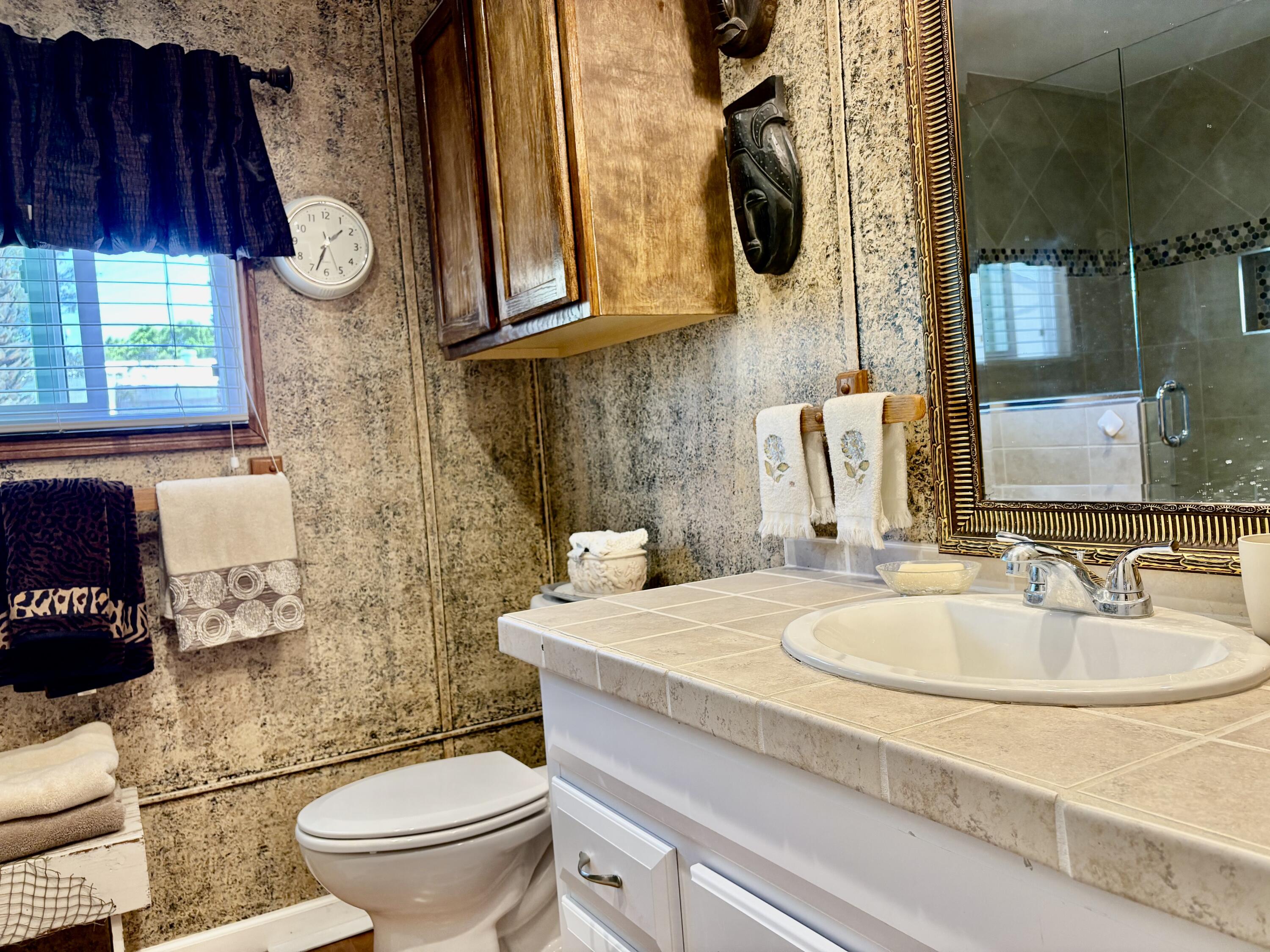 74711 Dillon Road, Unit 635 Desert Hot Springs, CA 92241 - Photo 12 of 55 a bathroom with a sink a toilet and mirror