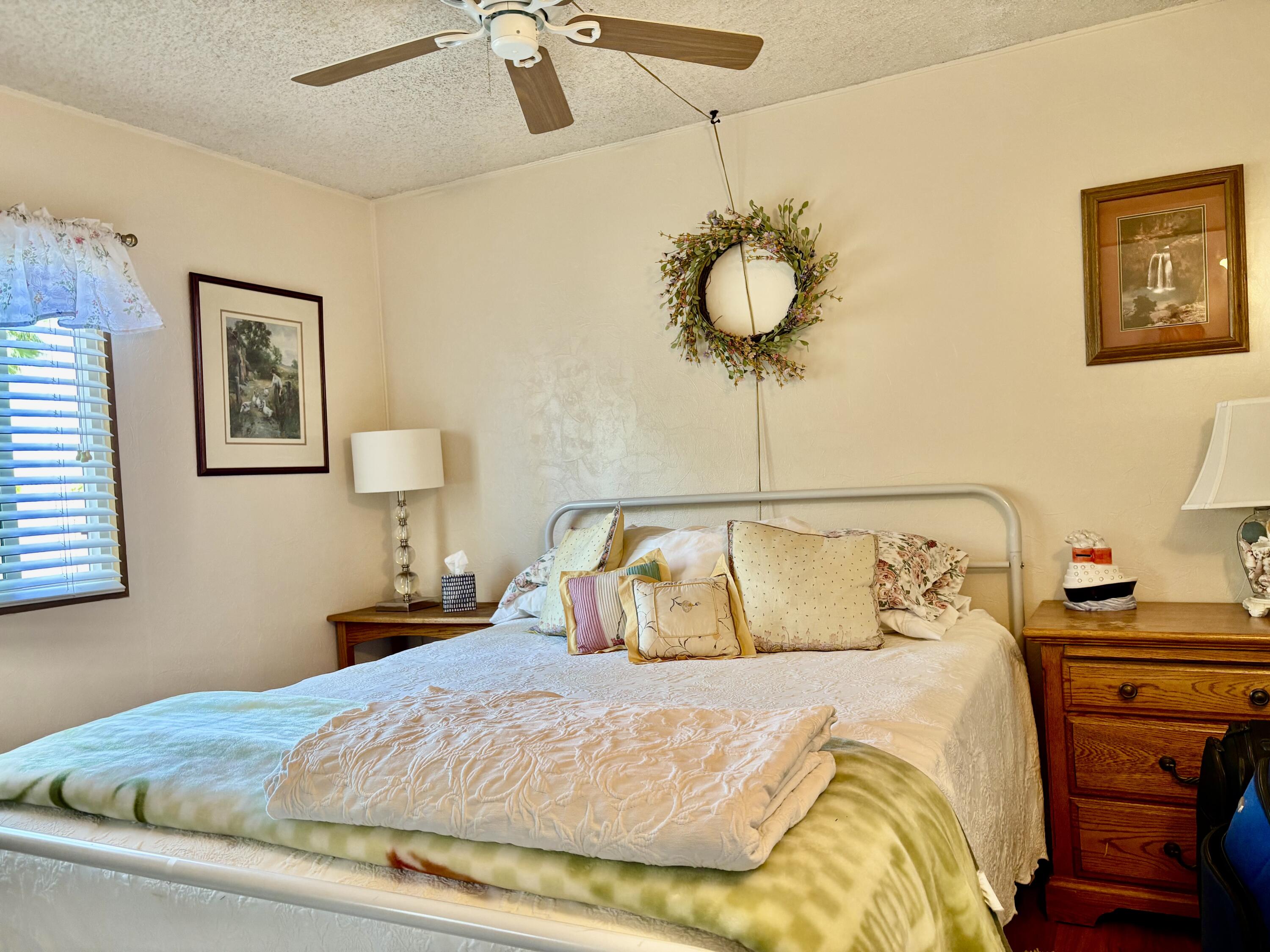74711 Dillon Road, Unit 635 Desert Hot Springs, CA 92241 - Photo 16 of 55 a bedroom with a bed and lamp on the dresser