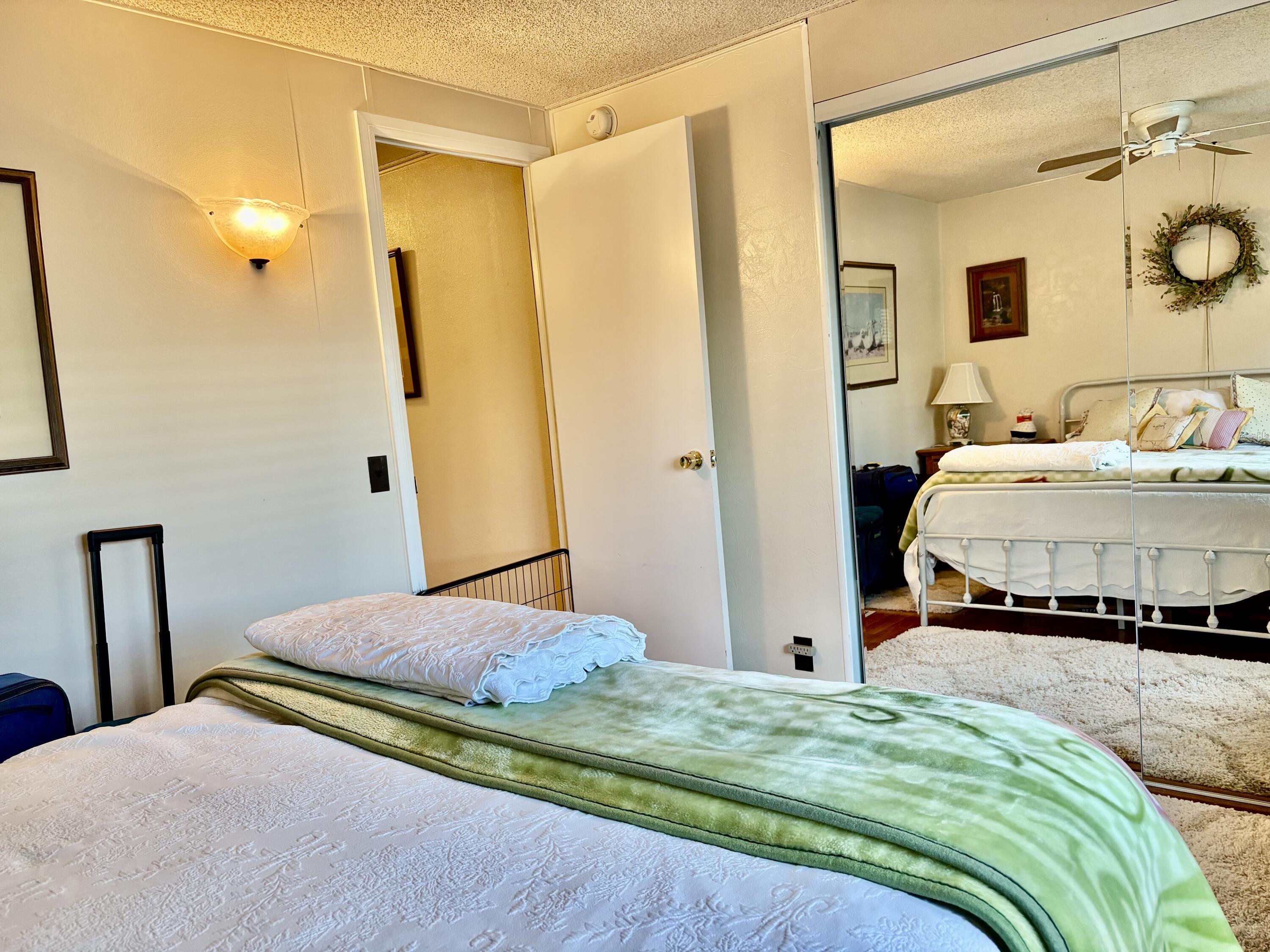 74711 Dillon Road, Unit 635 Desert Hot Springs, CA 92241 - Photo 17 of 55 a bedroom with a bed and a mirror